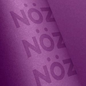 A close up of three Noz logos on Noz sunscreen in purple 