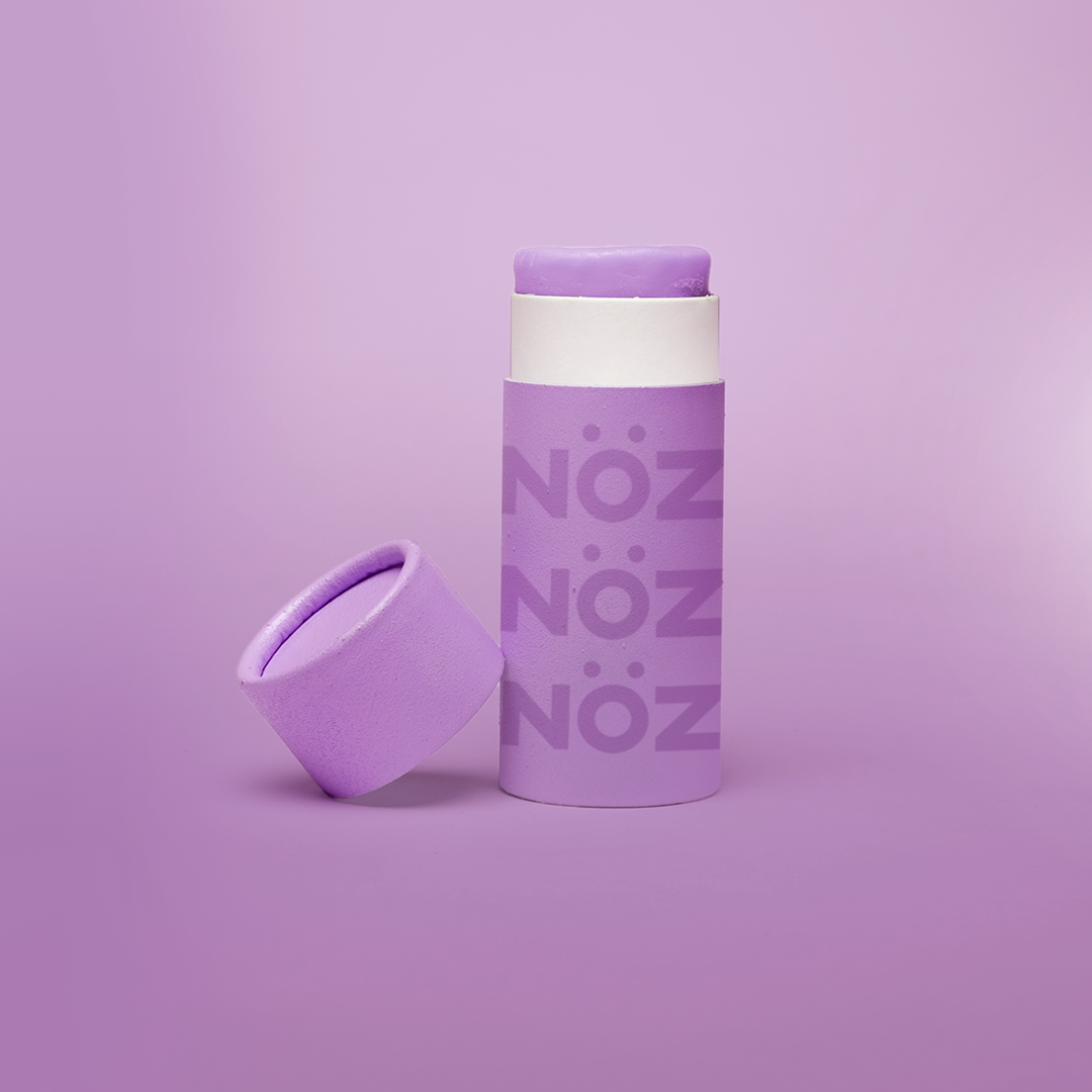 A front view of our Noz sunscreen in purple with the cap off showing some of the sunscreen stick